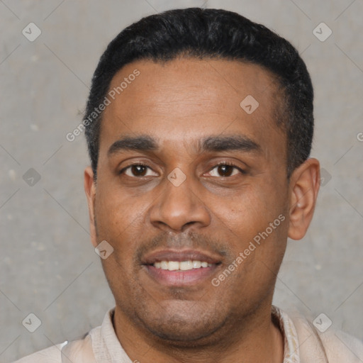 Joyful latino young-adult male with short  black hair and brown eyes