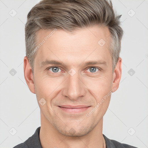 Joyful white adult male with short  brown hair and grey eyes