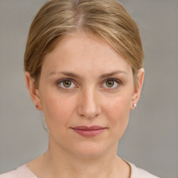 Joyful white young-adult female with medium  brown hair and blue eyes