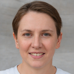 Joyful white young-adult female with short  brown hair and grey eyes