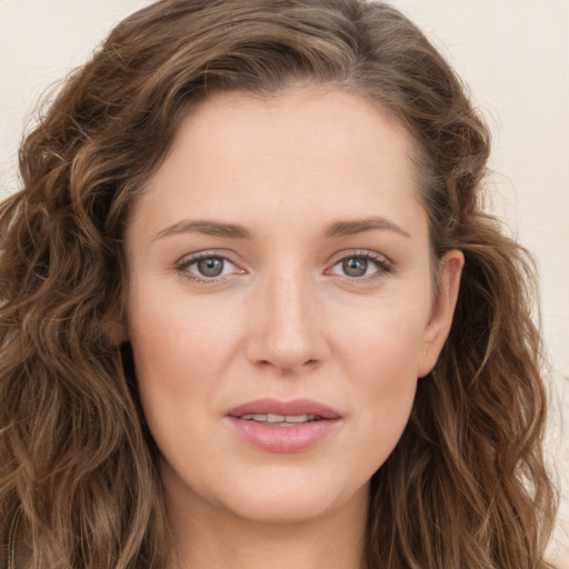 Joyful white young-adult female with long  brown hair and green eyes