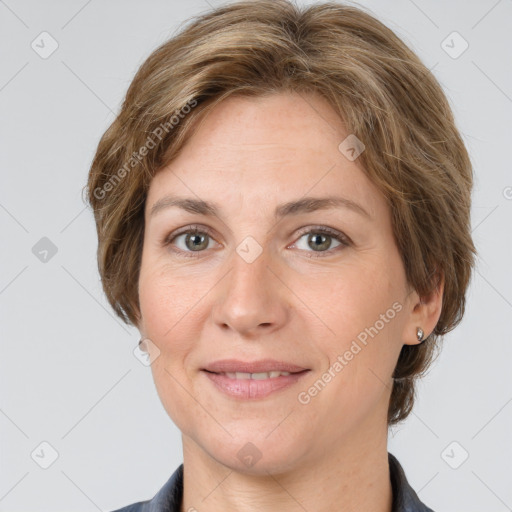 Joyful white adult female with medium  brown hair and grey eyes