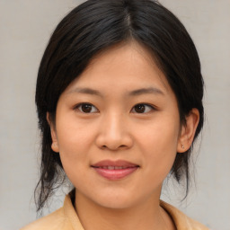 Joyful asian young-adult female with medium  brown hair and brown eyes