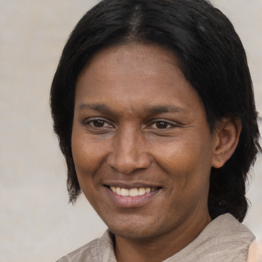 Joyful black adult female with short  brown hair and brown eyes