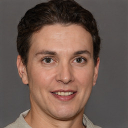 Joyful white adult male with short  brown hair and grey eyes