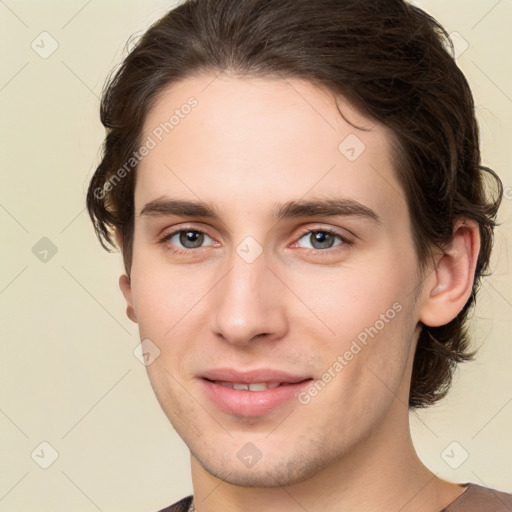 Joyful white young-adult male with medium  brown hair and brown eyes