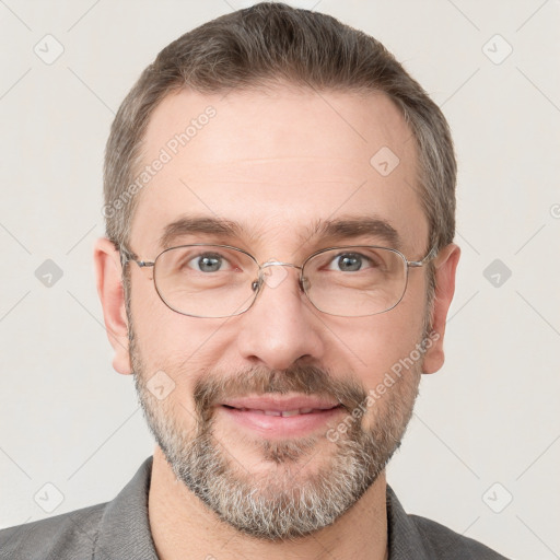 Joyful white adult male with short  brown hair and grey eyes