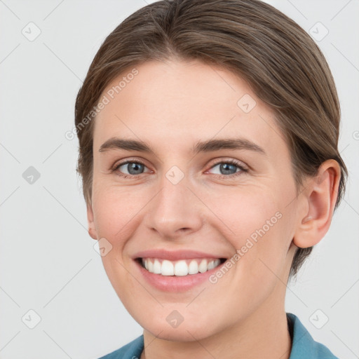 Joyful white young-adult female with short  brown hair and grey eyes