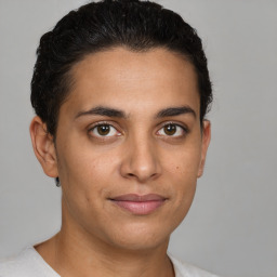 Joyful latino young-adult male with short  brown hair and brown eyes