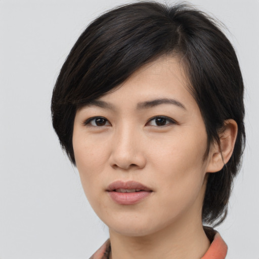 Joyful asian young-adult female with medium  brown hair and brown eyes