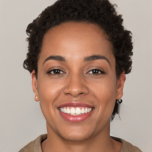 Joyful latino young-adult female with short  brown hair and brown eyes