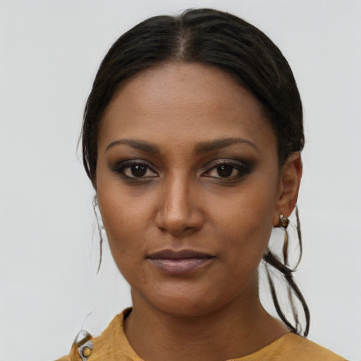 Joyful latino young-adult female with long  brown hair and brown eyes