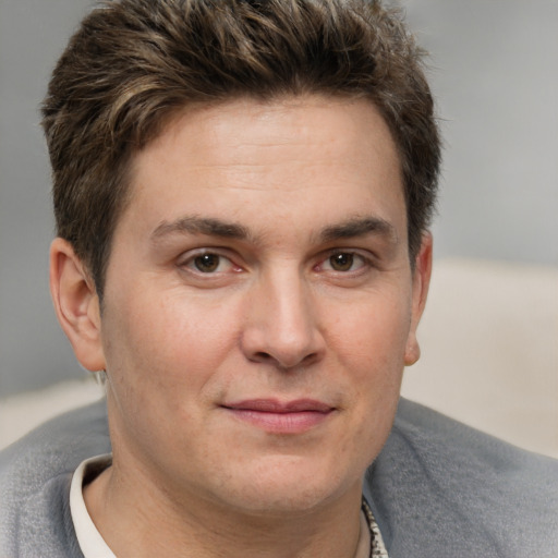 Joyful white adult male with short  brown hair and brown eyes