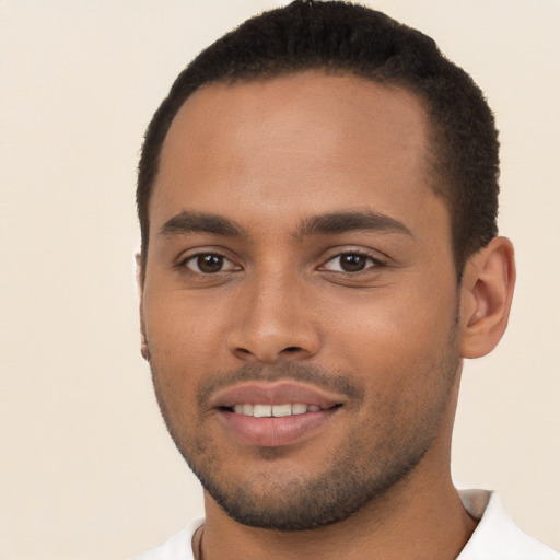 Joyful black young-adult male with short  brown hair and brown eyes