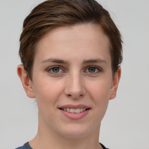 Joyful white young-adult female with short  brown hair and grey eyes