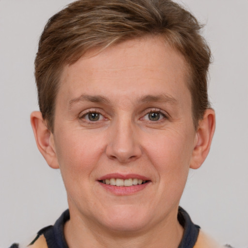 Joyful white adult female with short  brown hair and grey eyes