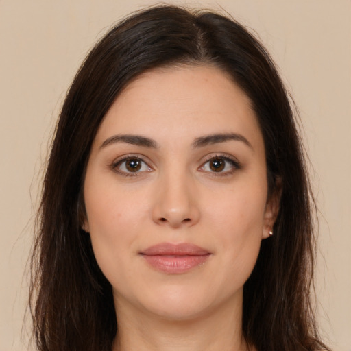 Joyful white young-adult female with long  brown hair and brown eyes