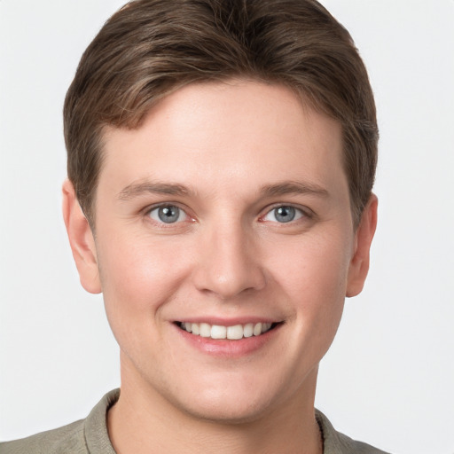 Joyful white young-adult male with short  brown hair and grey eyes