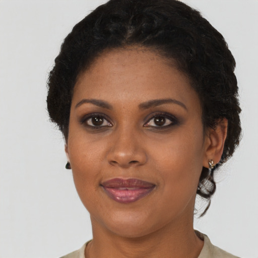 Joyful black young-adult female with short  brown hair and brown eyes
