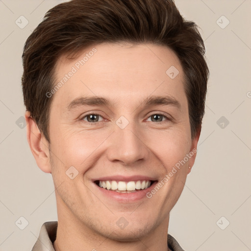 Joyful white young-adult male with short  brown hair and grey eyes