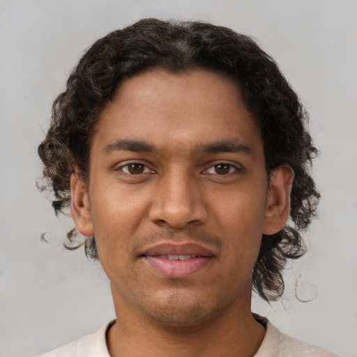 Joyful latino young-adult male with short  brown hair and brown eyes