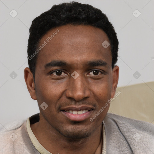 Joyful black young-adult male with short  black hair and brown eyes