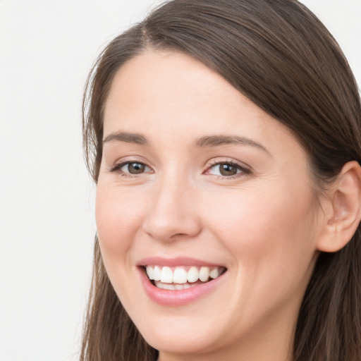 Joyful white young-adult female with long  brown hair and grey eyes