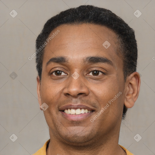 Joyful latino young-adult male with short  brown hair and brown eyes