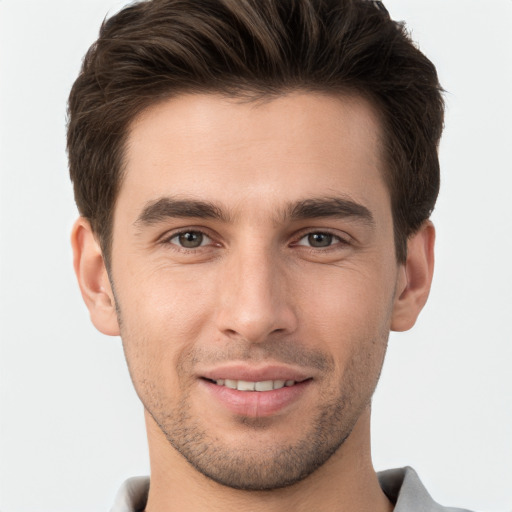 Joyful white young-adult male with short  brown hair and brown eyes