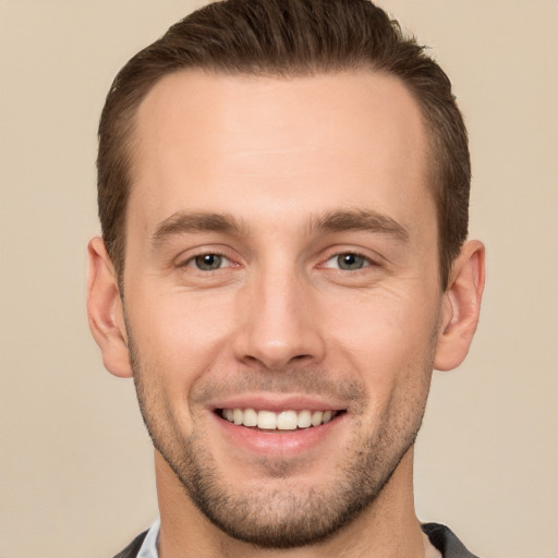 Joyful white young-adult male with short  brown hair and brown eyes