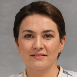 Joyful white adult female with short  brown hair and brown eyes