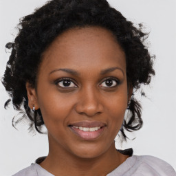 Joyful black young-adult female with medium  brown hair and brown eyes