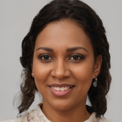Joyful black young-adult female with medium  brown hair and brown eyes