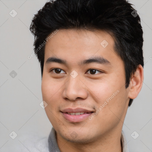 Joyful asian young-adult male with short  black hair and brown eyes