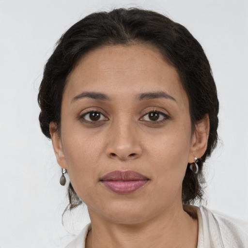 Joyful latino young-adult female with short  brown hair and brown eyes