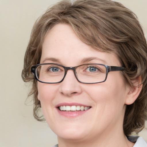 Joyful white adult female with medium  brown hair and blue eyes