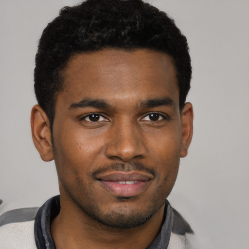 Joyful black young-adult male with short  black hair and brown eyes