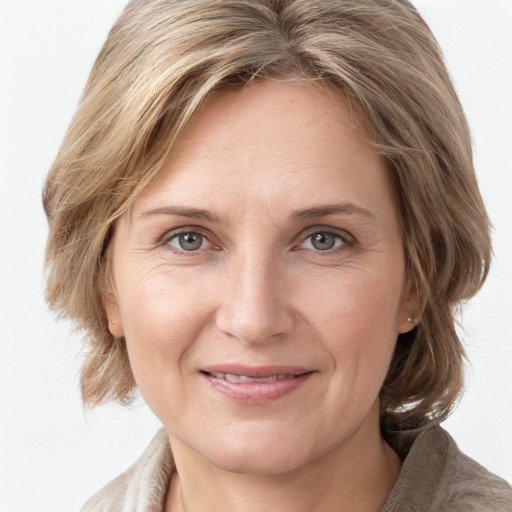 Joyful white adult female with medium  brown hair and grey eyes