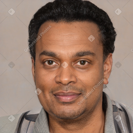 Joyful latino adult male with short  black hair and brown eyes