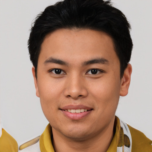 Joyful asian young-adult male with short  brown hair and brown eyes