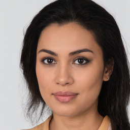 Joyful latino young-adult female with long  brown hair and brown eyes