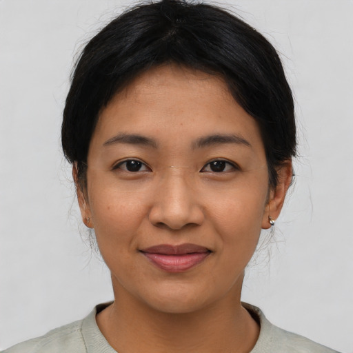 Joyful asian young-adult female with short  black hair and brown eyes