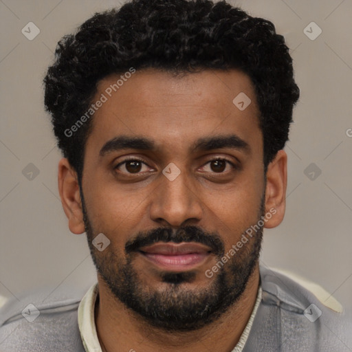 Joyful black young-adult male with short  black hair and brown eyes