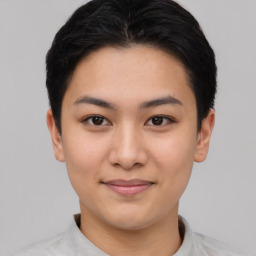 Joyful asian young-adult female with short  black hair and brown eyes