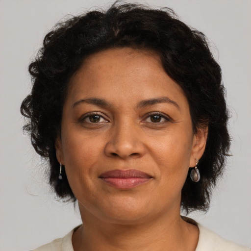 Joyful latino adult female with medium  brown hair and brown eyes