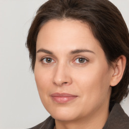 Joyful white young-adult female with medium  brown hair and brown eyes