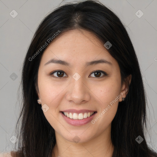 Joyful asian young-adult female with long  brown hair and brown eyes