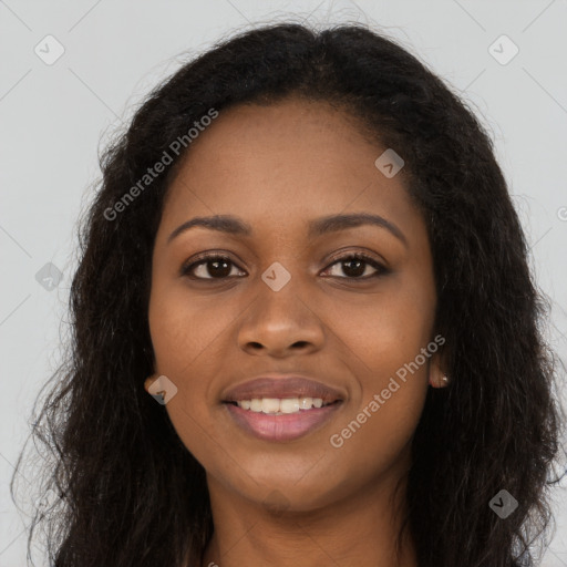 Joyful black young-adult female with long  brown hair and brown eyes