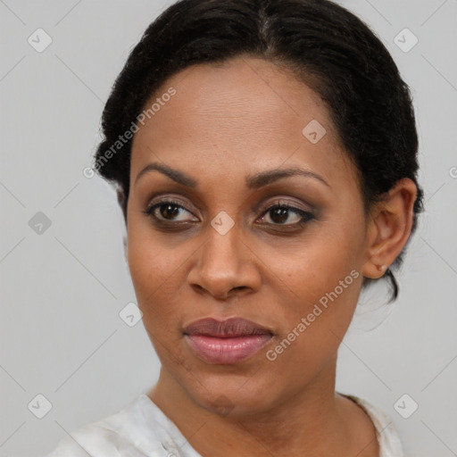 Joyful black adult female with short  brown hair and brown eyes