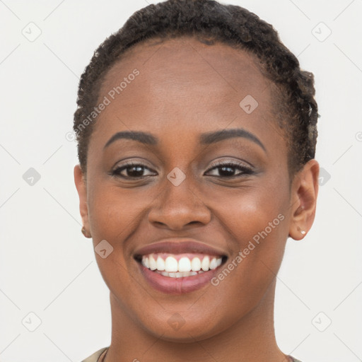 Joyful black young-adult female with short  brown hair and brown eyes